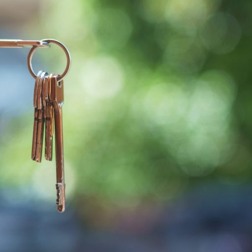 Key in door lock with blurry background,